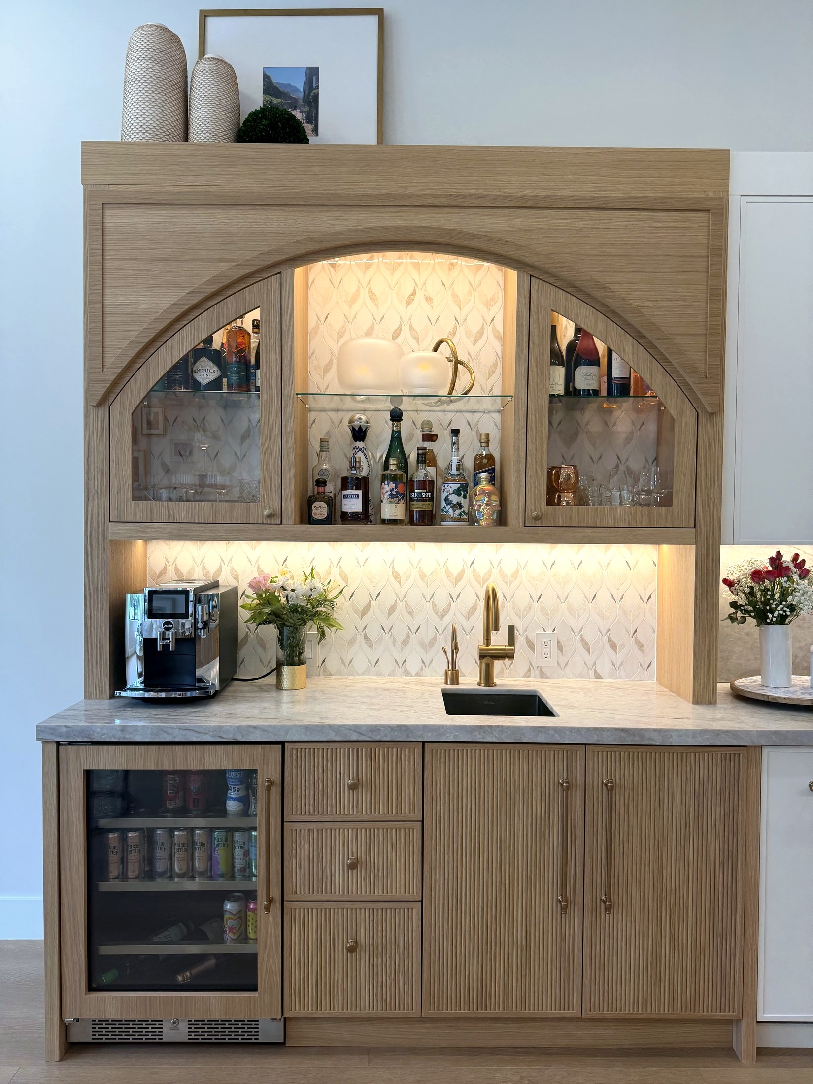 Arched custom wet bar with backlit shelving