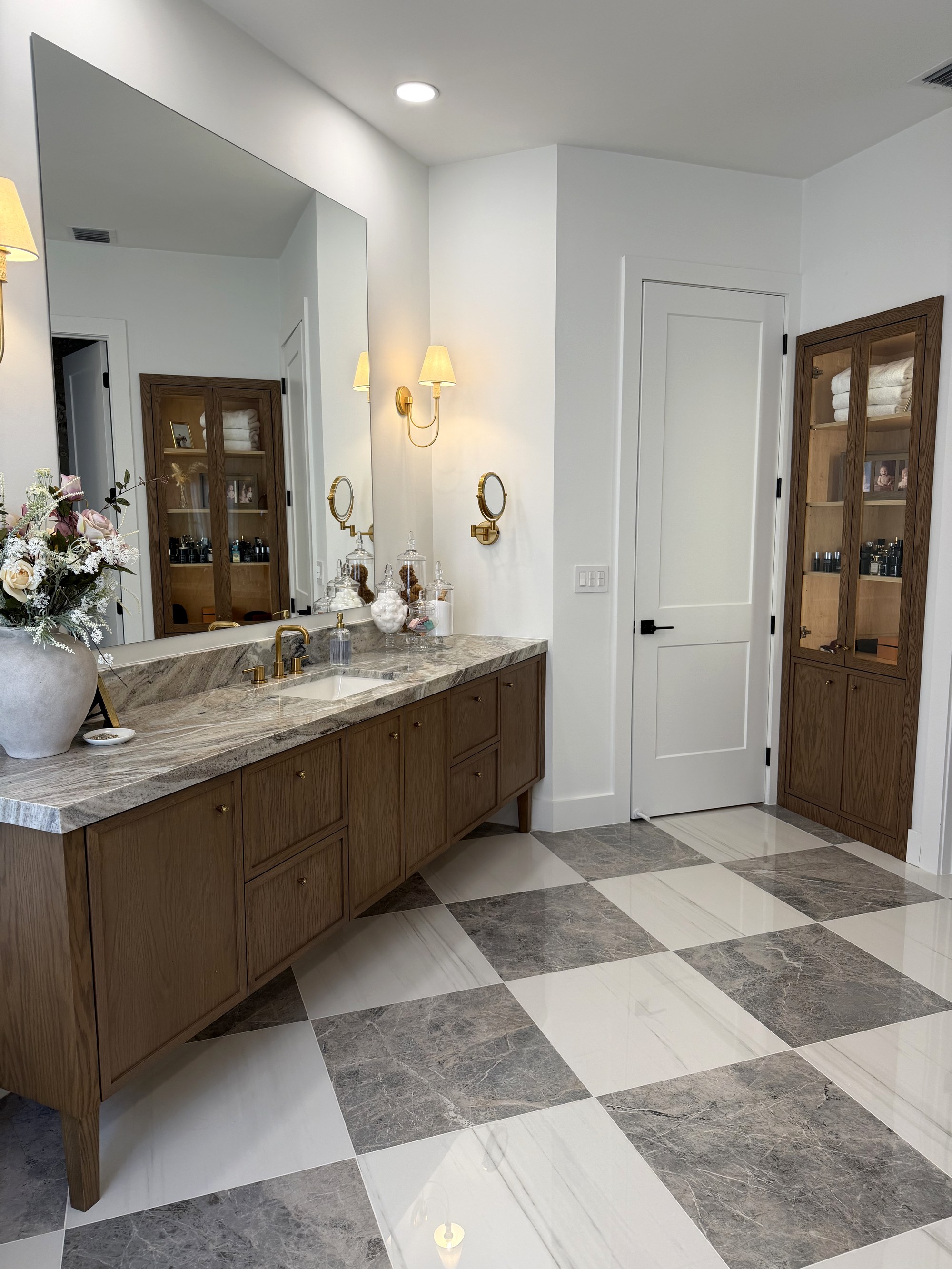 Custom marble primary bath with brass fixtures