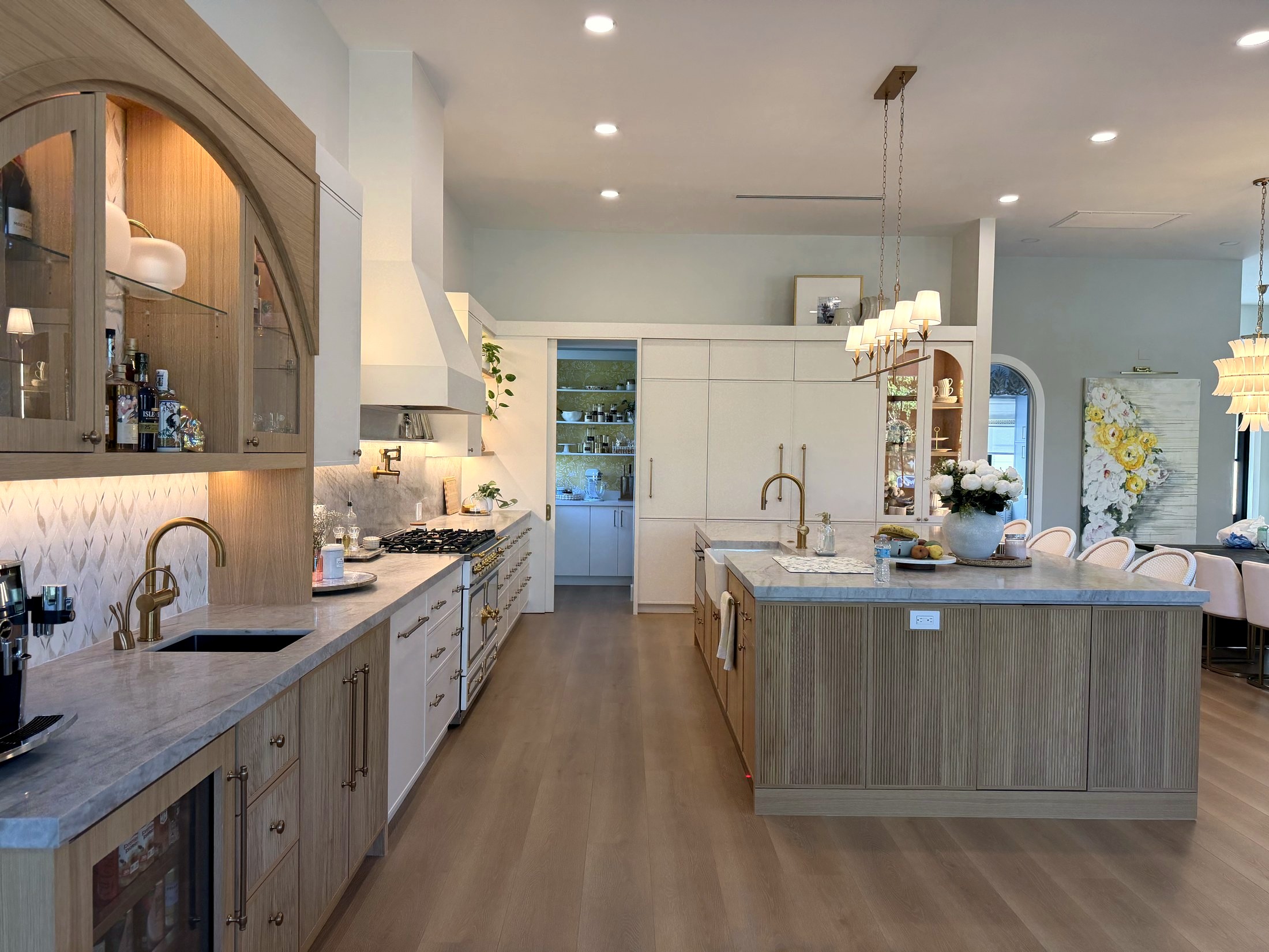 Custom estate kitchen with arched range hood and marble island
