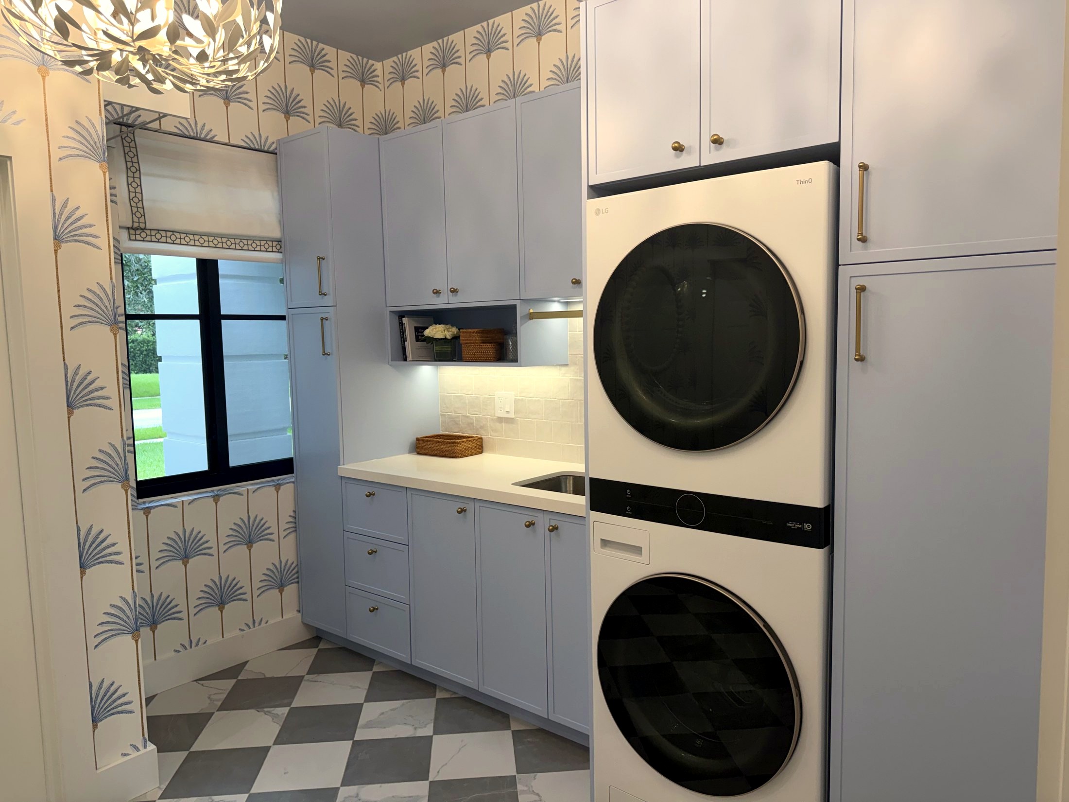 Custom laundry room with palm wallpaper